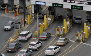 File photo of vehicles stopping at customs booths while entering the United States from the tunnel coming under the Detroit river from Windsor in downtown Detroit