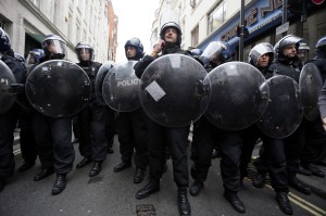 Police officers form a cordon after raiding a building used as a base for demonstrators protesting against the upcoming G8 summit in central London